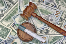 Gavel and syringe on top of cash