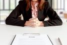 female in business attire, presenting resume